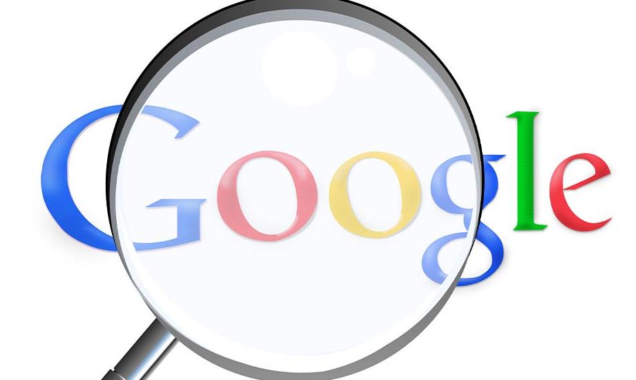An image of the Google logo under a magnifying glass